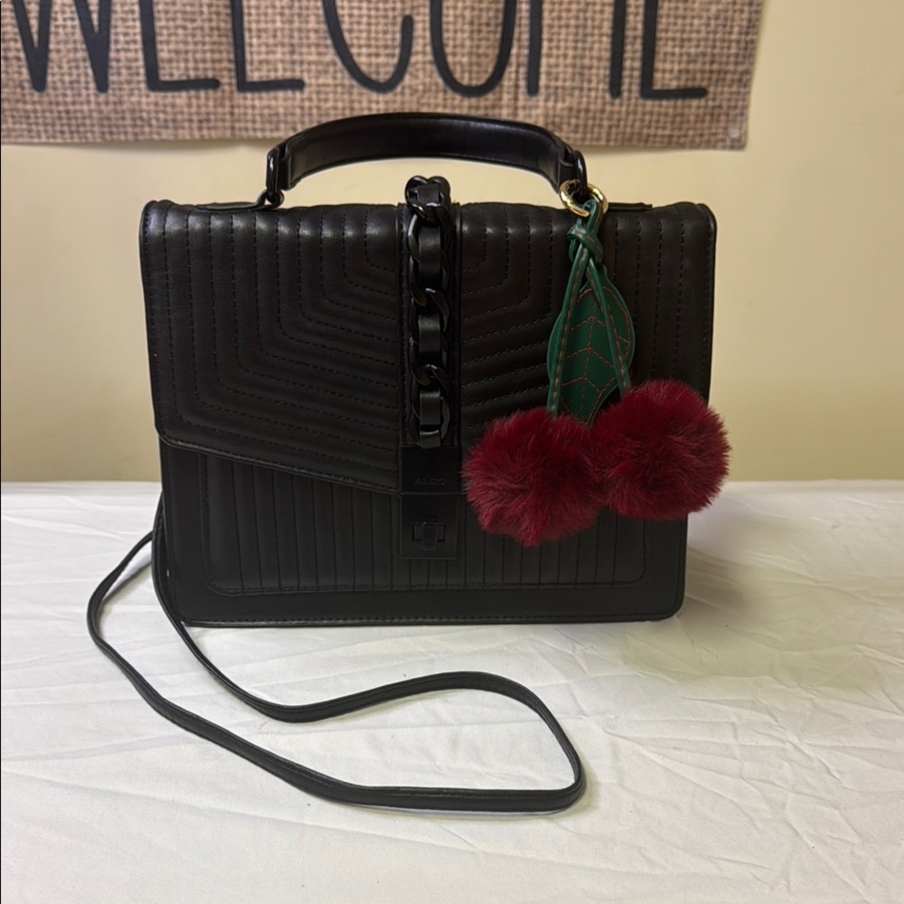 Aldo Black Crossbody Bag with Textured Finish and Flap Closure includes Pom Pom